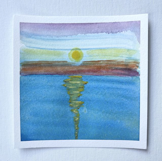 Watercolor of a pale yellow sun low over a calm blue sea, its reflection rippling down the water, under a band of violet sky.