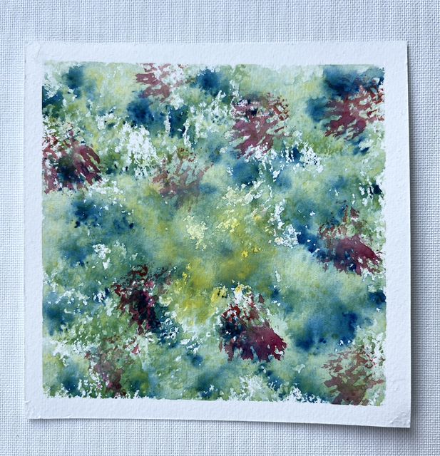 Abstract watercolor of mottled blues, greens and soft yellow with splashes of deep red-violet, on a square of white paper.