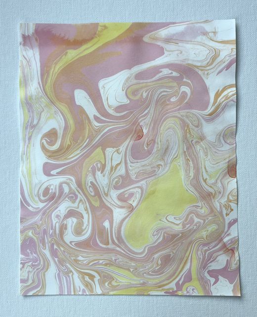 Marbled paper with swirling veins of soft pink, lavender and pale yellow alcohol ink.