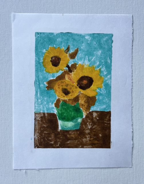 Monoprint of yellow sunflowers with brown centers in a green vase on a brown table, against a turquoise background.